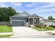 Inviting home exterior with a cozy front porch, landscaped lawn, and a gray garage door at 3026 Towne Mill Ave, Canton, GA 30114