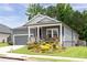 Exterior of a house with front porch, colorful landscaping, and a well-maintained lawn at 3026 Towne Mill Ave, Canton, GA 30114