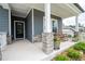 Welcoming front porch featuring rocking chairs, stone accents, and pretty plants at 3026 Towne Mill Ave, Canton, GA 30114
