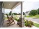 Relaxing front porch view with rocking chairs, stone accents, and lush greenery at 3026 Towne Mill Ave, Canton, GA 30114