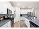 Well-lit kitchen featuring white cabinets, stainless steel appliances, and a gray tile backsplash at 3026 Towne Mill Ave, Canton, GA 30114