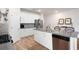 Bright kitchen featuring white cabinets, stainless steel appliances, and a center island with sink at 3026 Towne Mill Ave, Canton, GA 30114