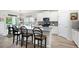 Open kitchen featuring an island with seating, stainless steel appliances, and white cabinets at 3026 Towne Mill Ave, Canton, GA 30114