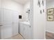 Laundry room with washer, dryer, storage cabinets, and hanging space at 3026 Towne Mill Ave, Canton, GA 30114