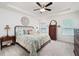 Bright main bedroom featuring a decorative bed, dresser, and natural light from windows at 3026 Towne Mill Ave, Canton, GA 30114