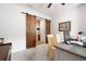 Office space with modern barn doors, desk, office chairs, and neutral carpet at 3026 Towne Mill Ave, Canton, GA 30114