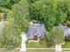 Aerial view of a luxury house with a pool surrounded by mature trees and situated near a golf course at 407 Amber Ln, Woodstock, GA 30189