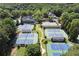 Comprehensive aerial view of the tennis facilities, clubhouse, and beautifully landscaped grounds at 407 Amber Ln, Woodstock, GA 30189