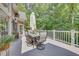 Back deck boasts outdoor dining area with room to entertain while enjoying the wooded view at 407 Amber Ln, Woodstock, GA 30189