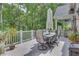 Back deck boasts outdoor dining area with room to entertain with wooded views at 407 Amber Ln, Woodstock, GA 30189