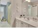 Bright bathroom featuring a vanity with white cabinets, a large mirror, and a shower/tub combo at 407 Amber Ln, Woodstock, GA 30189