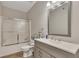 Bathroom features a shower with glass doors, a vanity, and modern fixtures for convenience at 407 Amber Ln, Woodstock, GA 30189