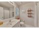 Well-lit bathroom featuring a single vanity, framed mirror, and shower with curtain at 407 Amber Ln, Woodstock, GA 30189
