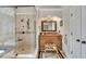 This bathroom features a large shower, cabinetry, and bench at 407 Amber Ln, Woodstock, GA 30189