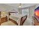 Serene bedroom featuring a ceiling fan and a classic wood bed with plush bedding at 407 Amber Ln, Woodstock, GA 30189
