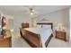 Inviting bedroom features a wood bed frame, a ceiling fan, and neutral decor at 407 Amber Ln, Woodstock, GA 30189