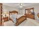 Spacious bedroom featuring carpeted floors, ceiling fan, dresser with mirror, and ample natural light at 407 Amber Ln, Woodstock, GA 30189