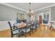 Traditional dining room with hardwood floors, gray walls, decorative chandelier and seating for eight at 407 Amber Ln, Woodstock, GA 30189