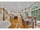 Bright dining room with hardwood floors, large arched windows, and adjacent kitchen at 407 Amber Ln, Woodstock, GA 30189