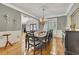 Traditional dining room with hardwood floors, gray walls, wainscotting and decorative chandelier at 407 Amber Ln, Woodstock, GA 30189