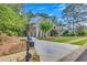 Charming home with long driveway, mature trees, and meticulously manicured lawn at 407 Amber Ln, Woodstock, GA 30189