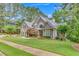 Charming two-story home with lush lawn, manicured landscaping and mature trees at 407 Amber Ln, Woodstock, GA 30189