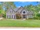 Charming two-story home with a manicured lawn and inviting stone accents at 407 Amber Ln, Woodstock, GA 30189