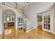 Grand foyer with hardwood floors, staircase, and views into the living spaces at 407 Amber Ln, Woodstock, GA 30189