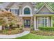 Close-up of a beautiful front door with stone accents and manicured landscaping at 407 Amber Ln, Woodstock, GA 30189