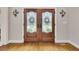 Elegant wooden double front doors with decorative glass panels, adding character at 407 Amber Ln, Woodstock, GA 30189