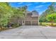Spacious two-car garage with ample driveway and landscaped backyard at 407 Amber Ln, Woodstock, GA 30189