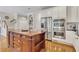 Kitchen featuring a large island with drawers, white cabinets, and stainless steel appliances at 407 Amber Ln, Woodstock, GA 30189