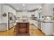 Well-lit kitchen with white cabinets, stainless steel appliances, and center island at 407 Amber Ln, Woodstock, GA 30189