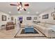 Open-concept living area featuring a plush sectional sofa and an area rug, bathed in natural light at 407 Amber Ln, Woodstock, GA 30189