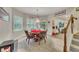 Cozy living room with a unique game table set, bright windows, and access to the backyard at 407 Amber Ln, Woodstock, GA 30189