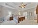 Spacious main bedroom with tray ceiling, carpet, and French doors leading to the bathroom at 407 Amber Ln, Woodstock, GA 30189