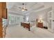 Spacious main bedroom with tray ceiling, carpet, and access to a patio at 407 Amber Ln, Woodstock, GA 30189