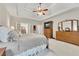 This main bedroom features a trey ceiling, ceiling fan, sitting area, and natural light at 407 Amber Ln, Woodstock, GA 30189