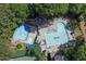 Aerial shot of a community pool featuring a slide, a splash pad, lounge chairs, and ample space at 407 Amber Ln, Woodstock, GA 30189