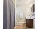 Well-lit bathroom with dual vanity, tile floor, and a shower with a gray curtain at 532 Lemon Ne St, Marietta, GA 30060