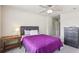 Comfortable bedroom featuring a cozy bed with gray headboard, a ceiling fan, a side table, and ample space at 532 Lemon Ne St, Marietta, GA 30060