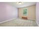 Cozy bedroom with lavender walls, a window, and a small orange bench at 532 Lemon Ne St, Marietta, GA 30060