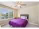 Cozy bedroom featuring a comfy bed with gray headboard, ceiling fan, and a large window offering natural light at 532 Lemon Ne St, Marietta, GA 30060