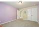 Bedroom with lavender accent wall and adjoining room with closet at 532 Lemon Ne St, Marietta, GA 30060