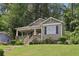 Well-kept home featuring a cozy front porch with manicured rose bushes lining the walkway on a sunny day at 532 Lemon Ne St, Marietta, GA 30060