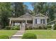 Charming home featuring a welcoming front porch, well-maintained lawn, and beautifully landscaped garden at 532 Lemon Ne St, Marietta, GA 30060