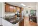 Well-equipped kitchen with sleek granite countertops, wooden cabinetry, stainless steel appliances, and a breakfast bar at 532 Lemon Ne St, Marietta, GA 30060