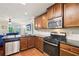 Modern kitchen with stainless steel appliances, granite countertops, wood floors, and wood cabinets at 532 Lemon Ne St, Marietta, GA 30060