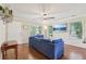 Bright living room with a comfortable blue sofa, gleaming hardwood floors, and natural light from several windows at 532 Lemon Ne St, Marietta, GA 30060