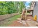 Spacious backyard featuring a wooden deck with stairs and a partially fenced yard with mature trees at 6918 Heritage Pl, Acworth, GA 30102